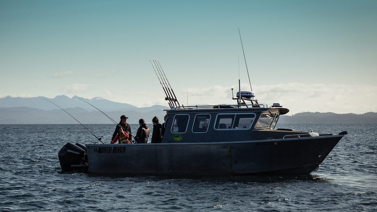 The boys fishing on a boat