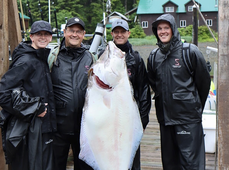 4 men posing in front of their catch