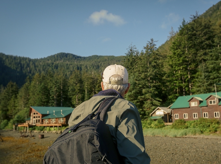 looking over the shoulder of a man with backback